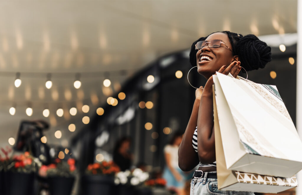 Happy female retail shopper with bags